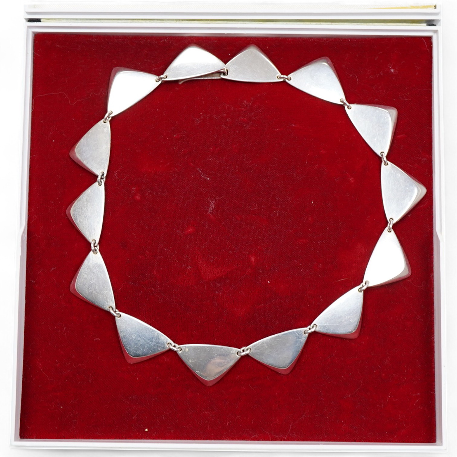 Hans Hansen, a modernist silver necklace, Denmark, composed of triangular linking in silver, to a concealed hook clasp, length 37.5cm, signed Hans Hansen, numbered 319, stamped Denmark, Swedish assay marks, gross weight